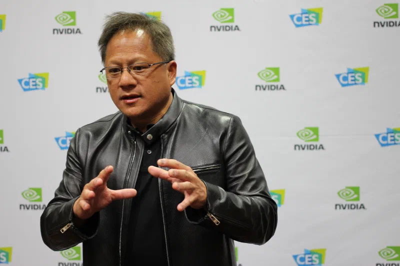 Jensen Huang wearing a black leather jacket and gesturing, photographed in January 2017.